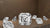 Asscher cut diamond showcasing step cut facets with surrounding loose diamonds on a warm brown background for jewellery presentation.