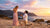 Couple celebrating a romantic beach proposal at sunset with scenic coastal views, one of the best places to propose in the USA