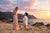 Couple celebrating a romantic beach proposal at sunset with scenic coastal views, one of the best places to propose in the USA
