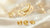 Golden Scorpio zodiac symbol with yellow birthstones on soft luxury background