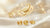 Golden Scorpio zodiac symbol with yellow birthstones on soft luxury background