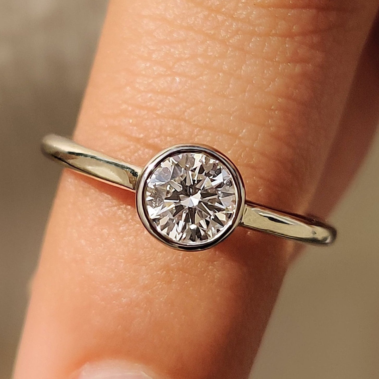 Bezel set diamond ring with secure and sleek setting.

