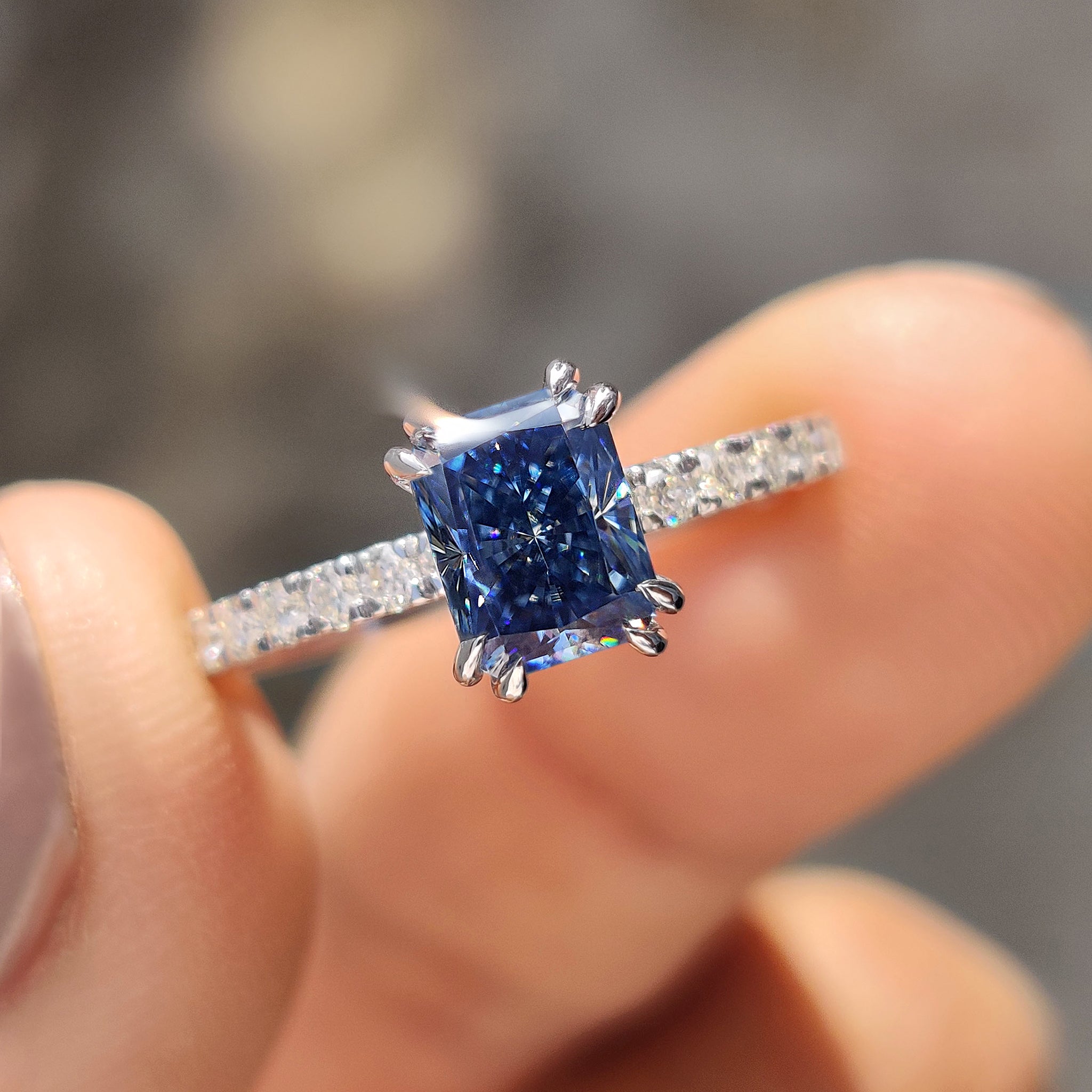 Blue moissanite ring set in a stylish design.
