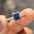 Blue moissanite ring set in a stylish design.
