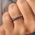 White gold band crafted in a double cross pattern with round moissanite stones.