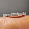 Baguette and round cut wedding band crafted with prong settings in white gold.