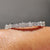 Baguette and round cut wedding band crafted with prong settings in white gold.