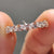 Anniversary gift for her featuring marquise and round cut moissanite in handmade setting.