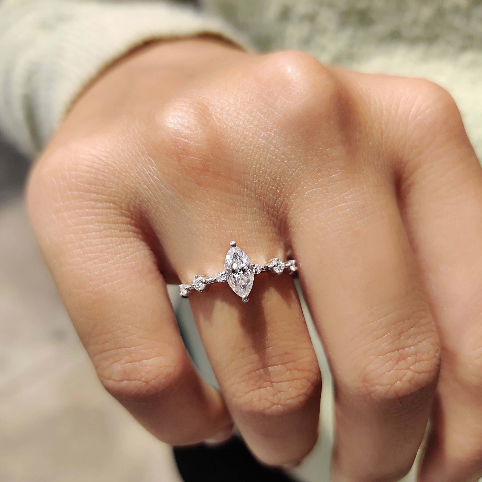 Round moissanite side stones add sweet light accents.