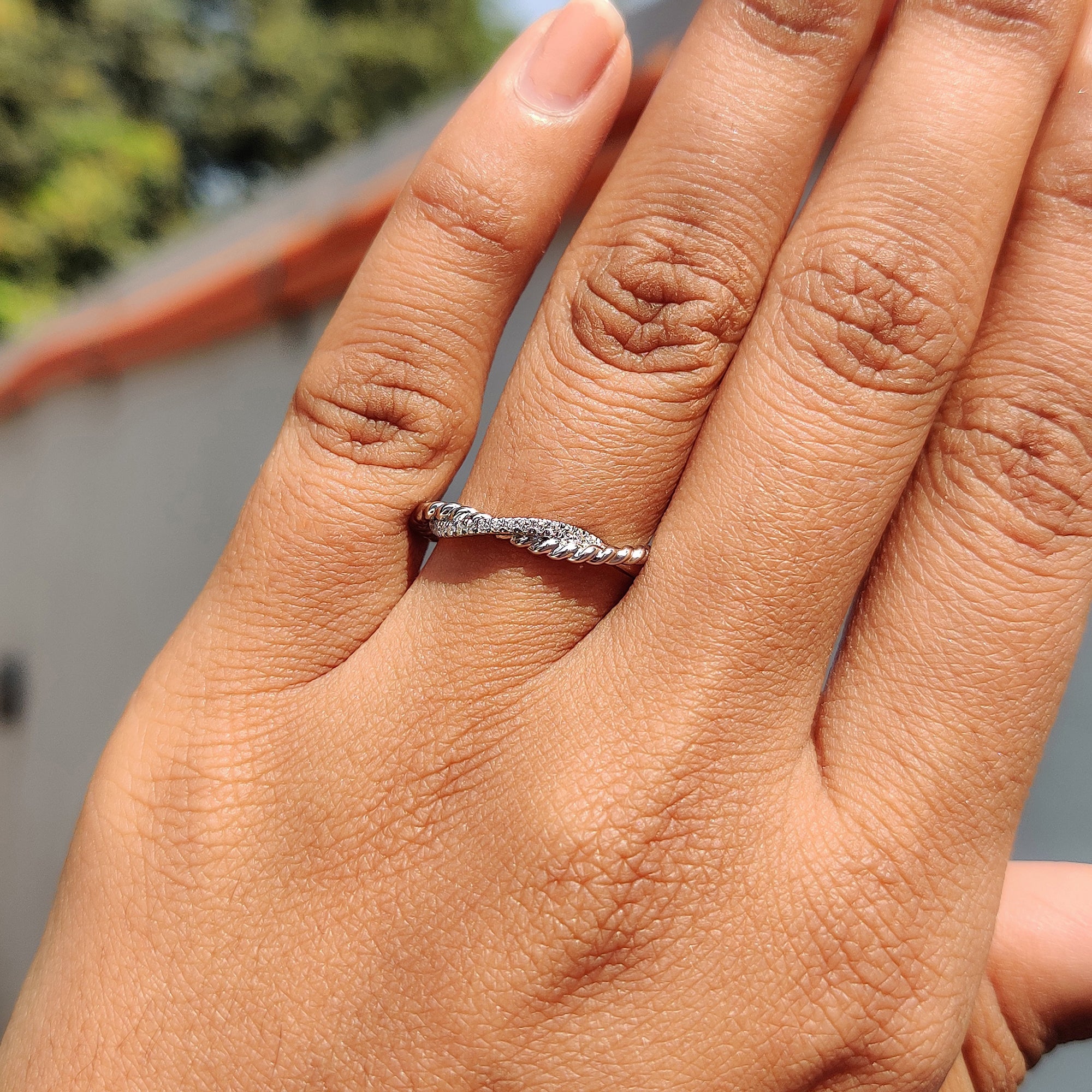 Twisted rope pave band featuring round cut moissanite in dual rows.
