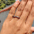 Twisted rope pave band featuring round cut moissanite in dual rows.
