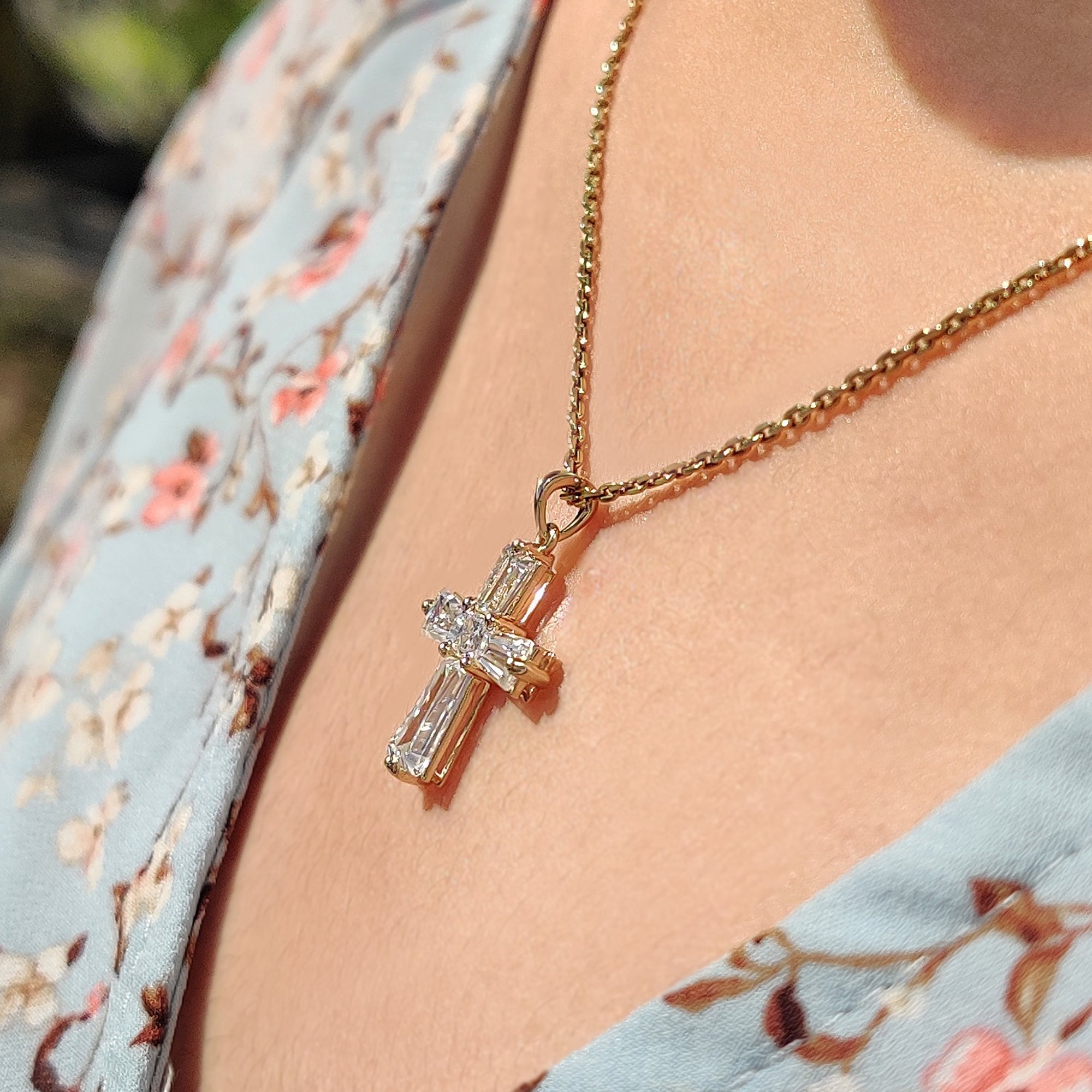 Cross moissanite pendant with princess cut stones in white gold.
