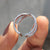 Moissanite round cut wedding band designed in a full eternity criss cross layout.