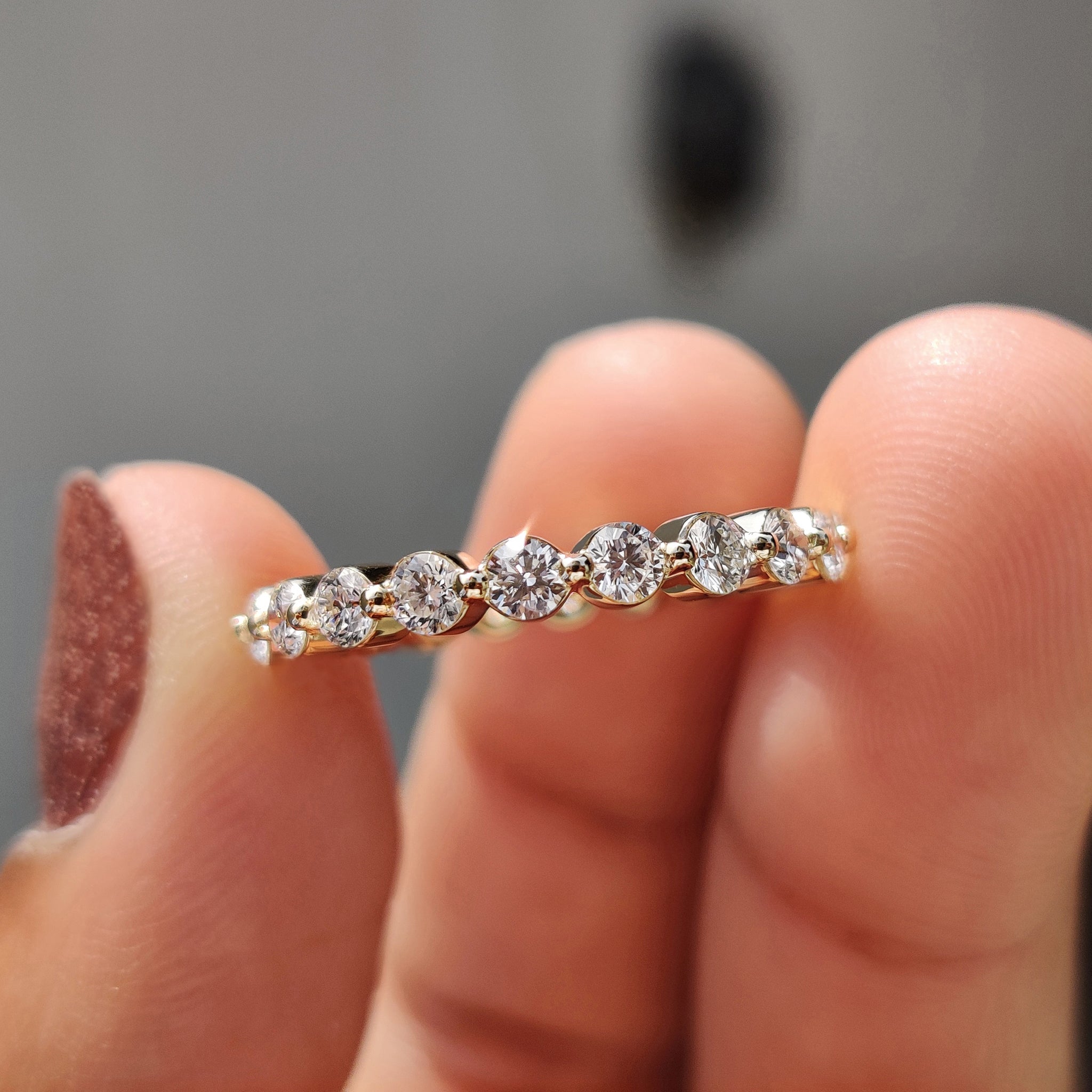 Lab diamond eternity band shown with sparkling diamonds.