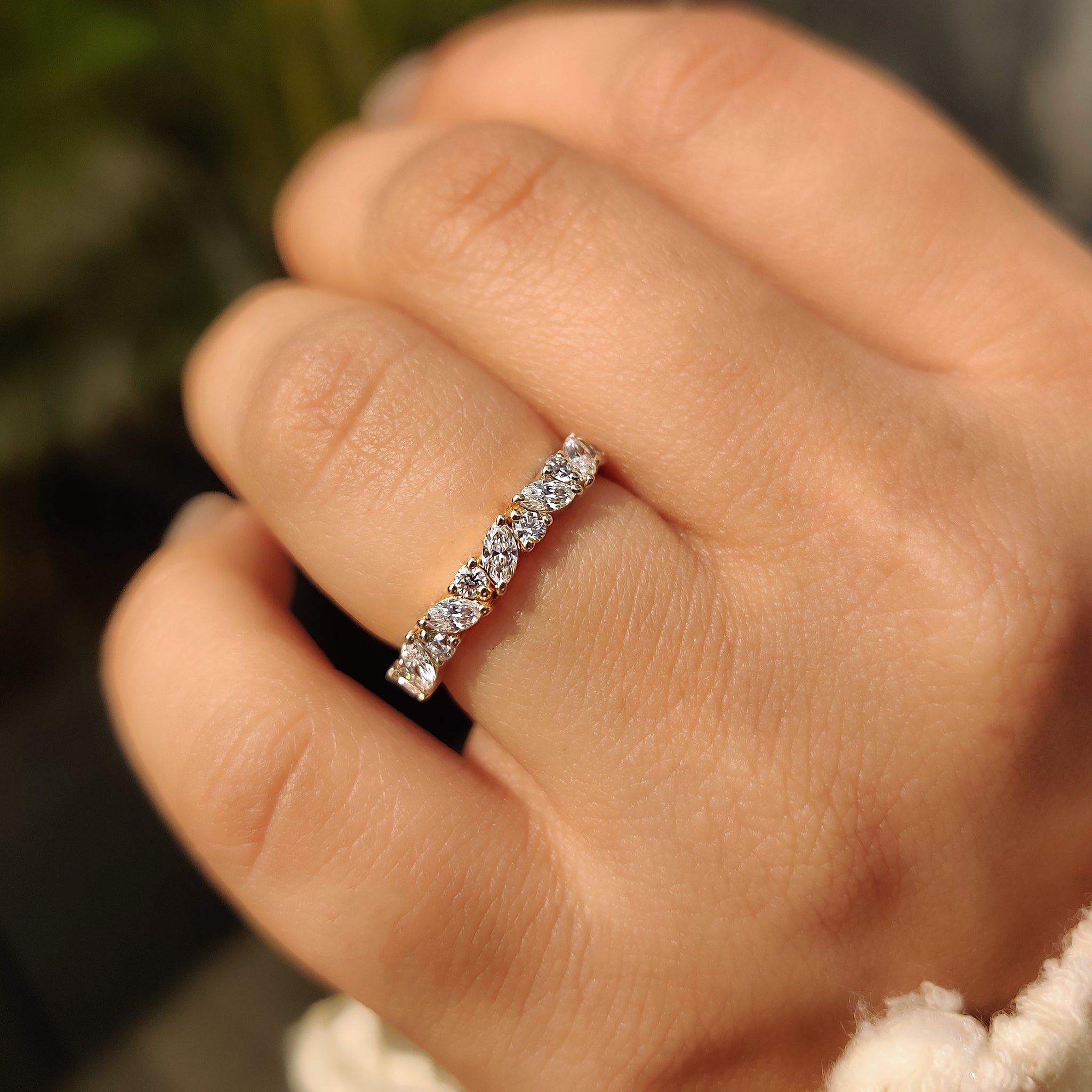 Custom wedding band crafted with marquise and round stones.
