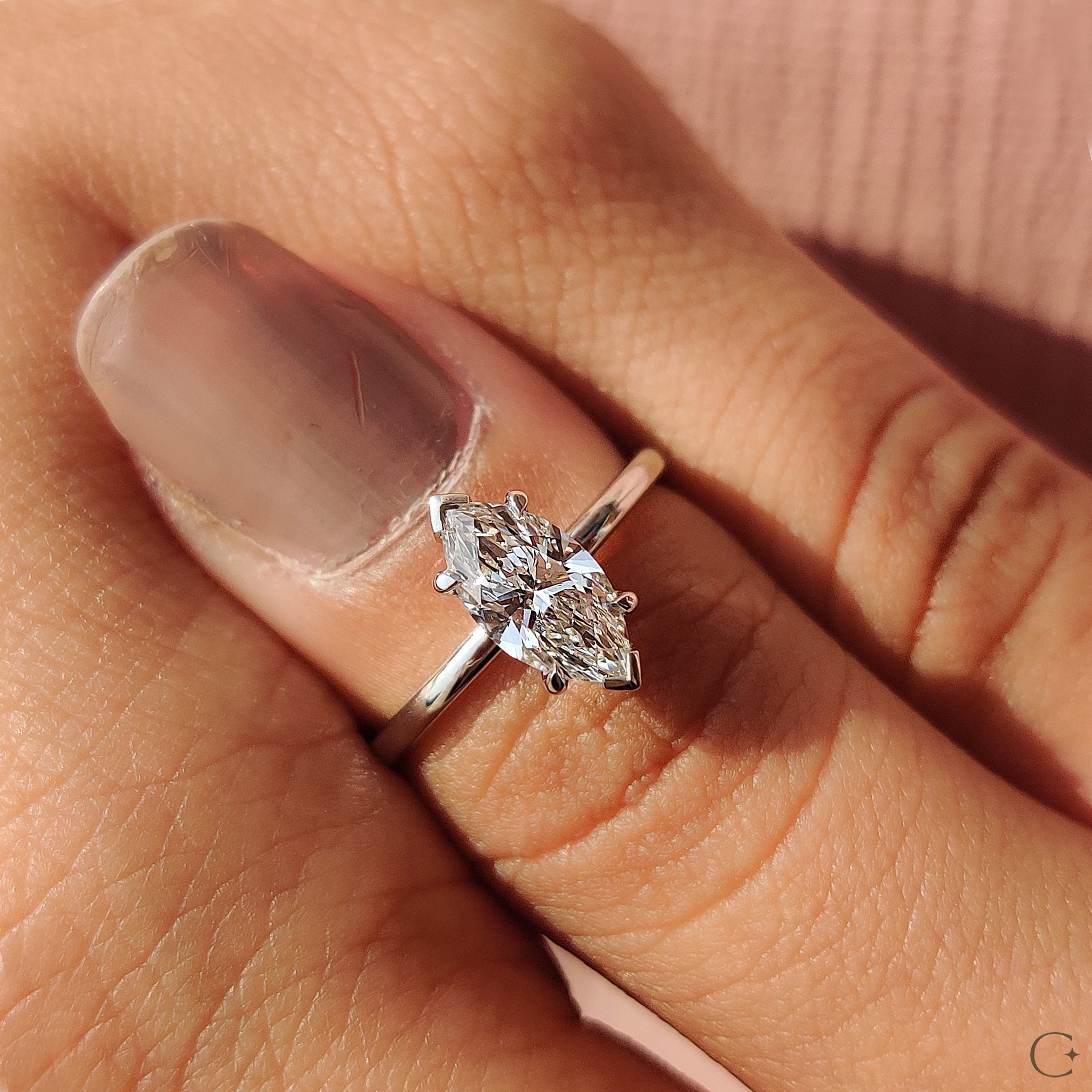White gold engagement ring with a sparkling diamond.
