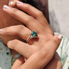 Oval cut ring in a yellow gold bridal set with handmade jewelry details.
