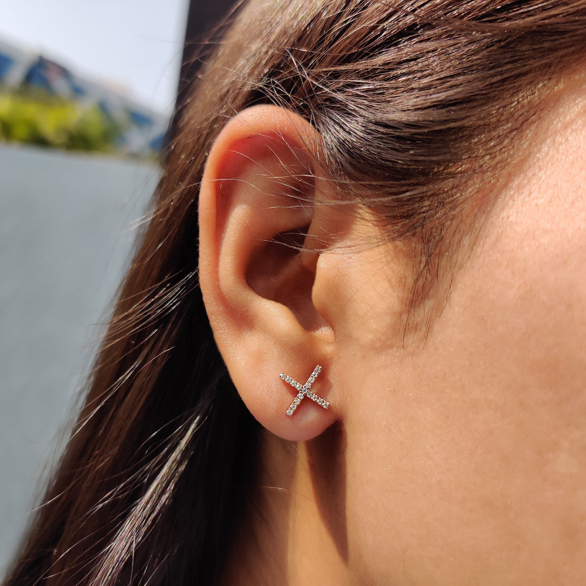 Earrings for women designed as X shaped earrings with prong settings for daily wear.
