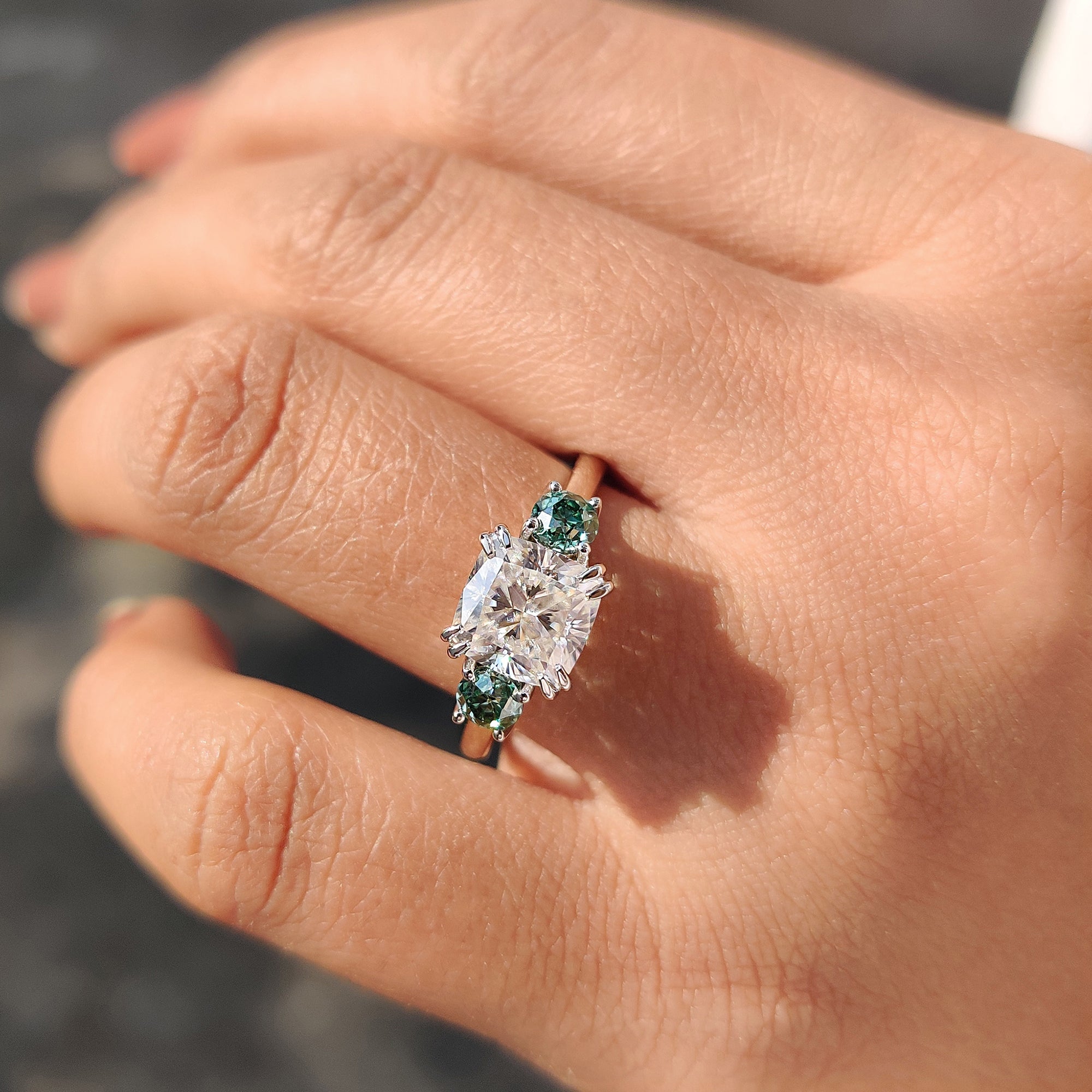 Unique green round cut side stone Moissanite ring.