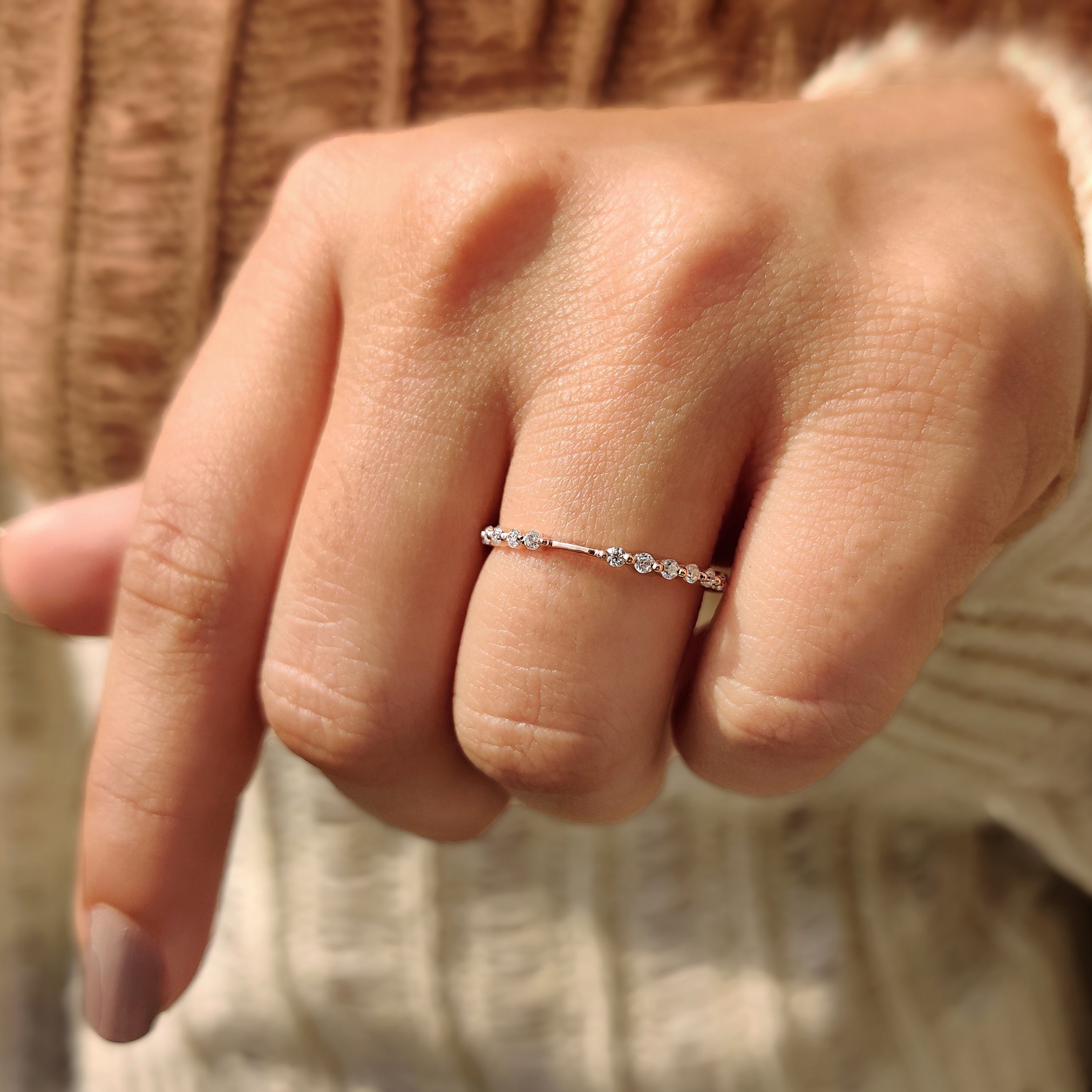 Rose gold wedding band with lab grown diamonds.
