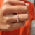 Round cut wedding band with prong setting band.