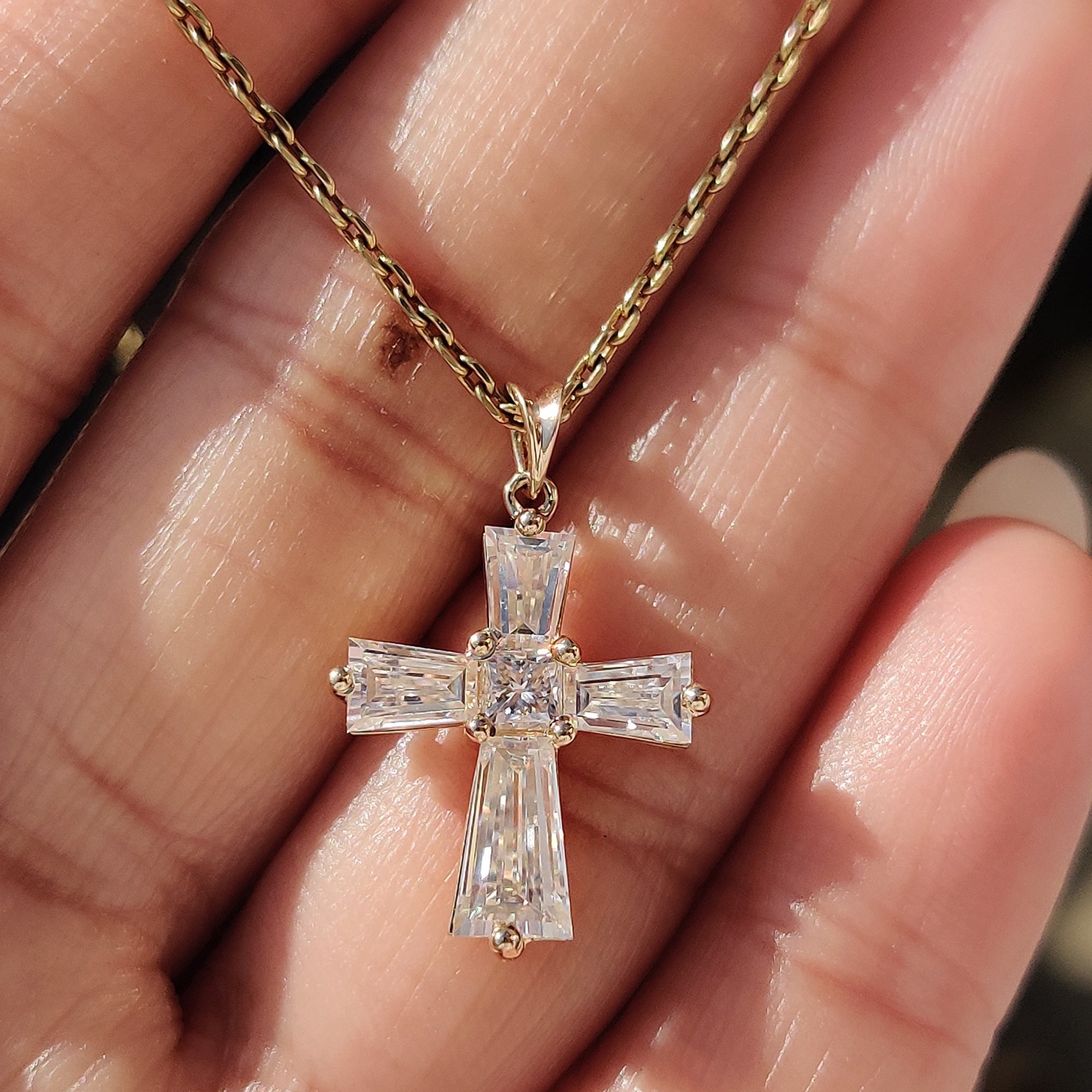 Princess cut pendant with tapered baguette stones and prong setting.
