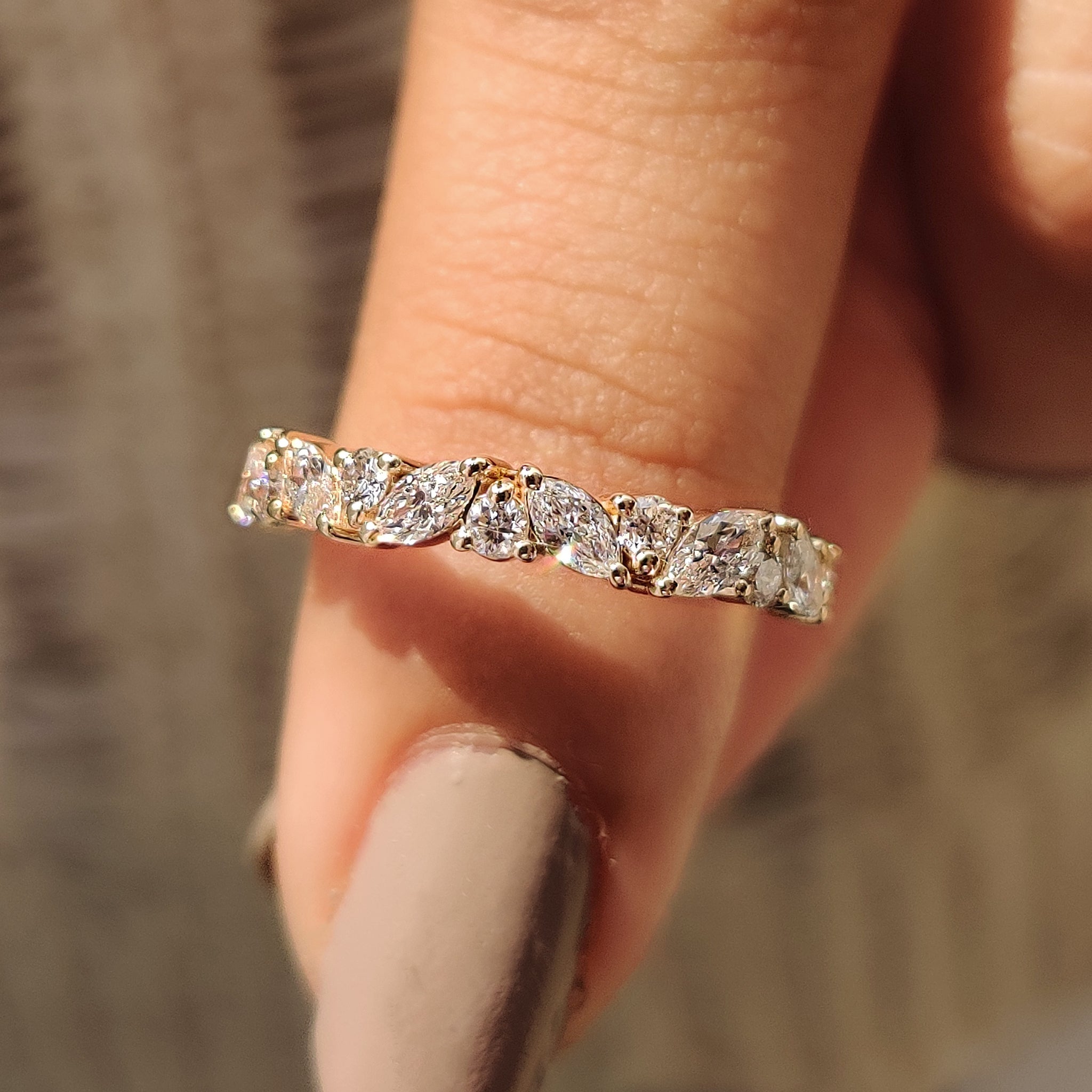 Marquise and round wedding band in yellow gold.
