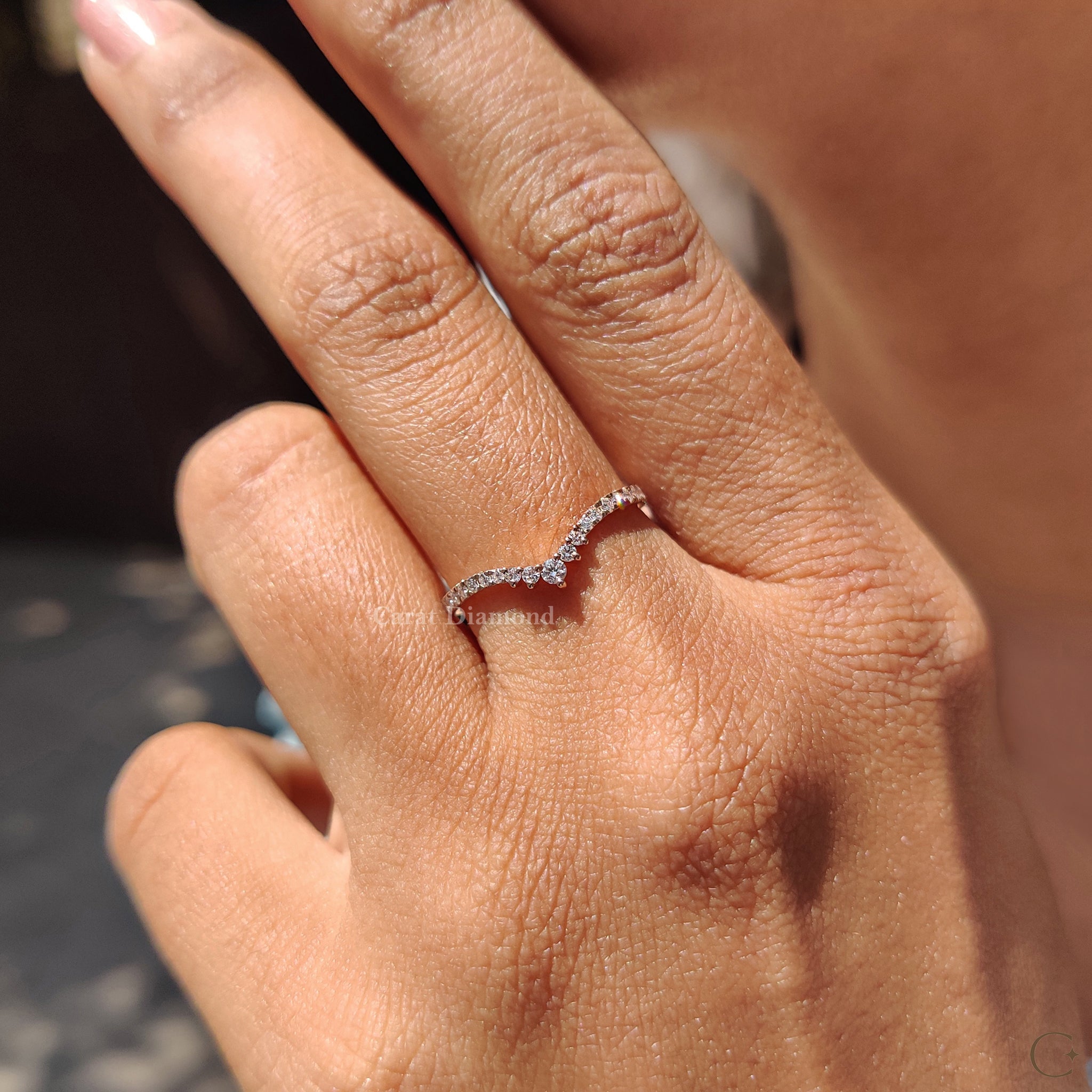 Prong setting used in a detailed and secure diamond band.

