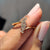 Asymmetrical cluster ring brings a fresh bold design.