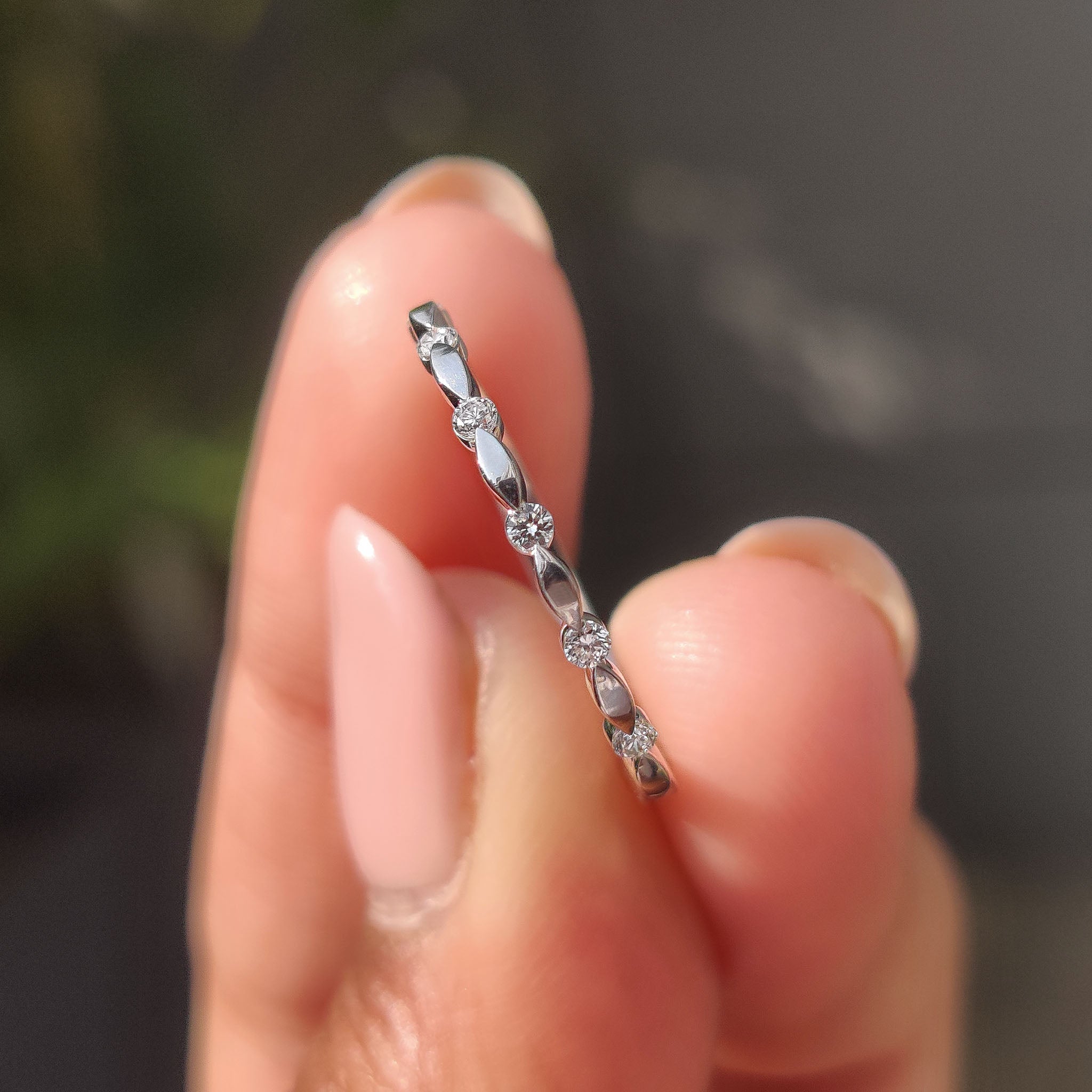 White gold diamond wedding band with distance pave and half eternity design.
