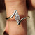 Three stone ring with round and pear diamonds.
