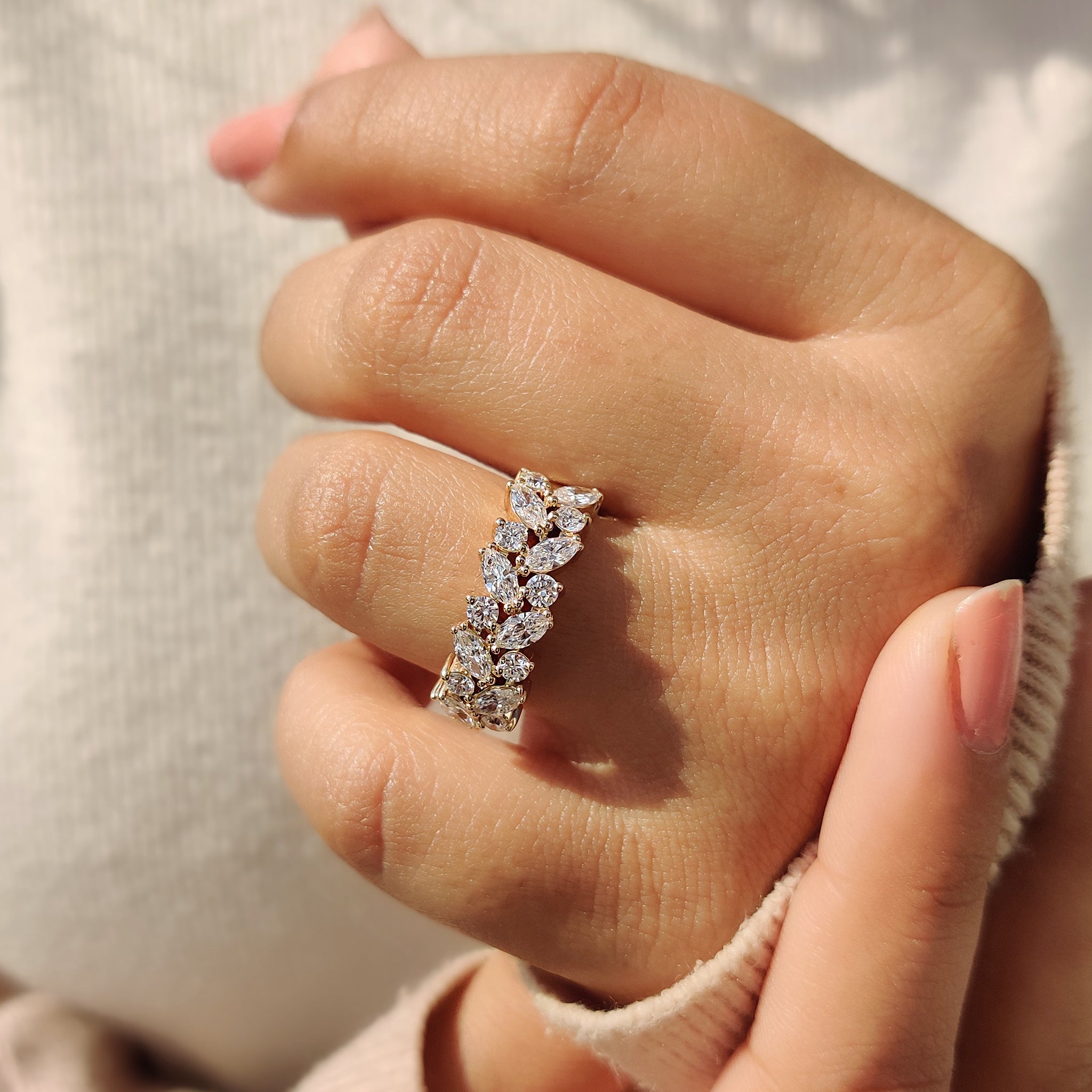 Half eternity wedding band worn on a woman's hand.

