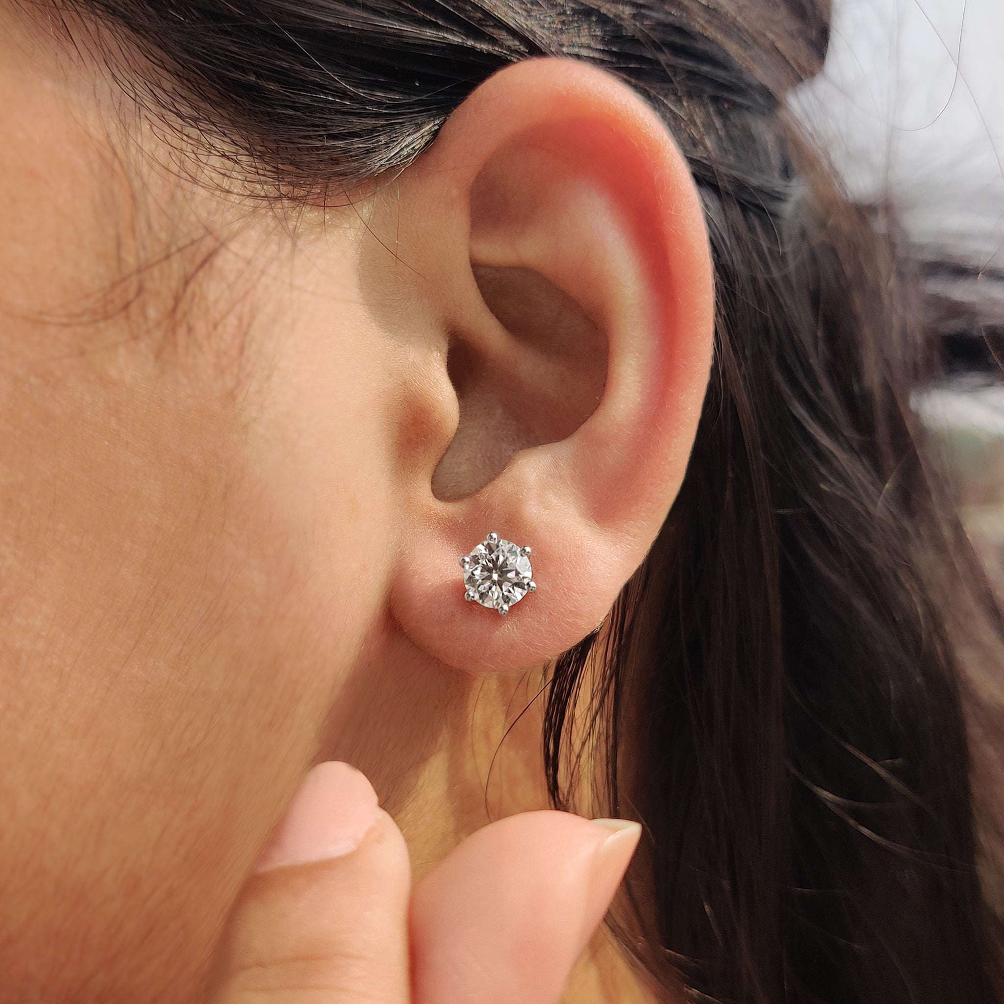 Six prong diamond earrings in a sleek white gold setting.