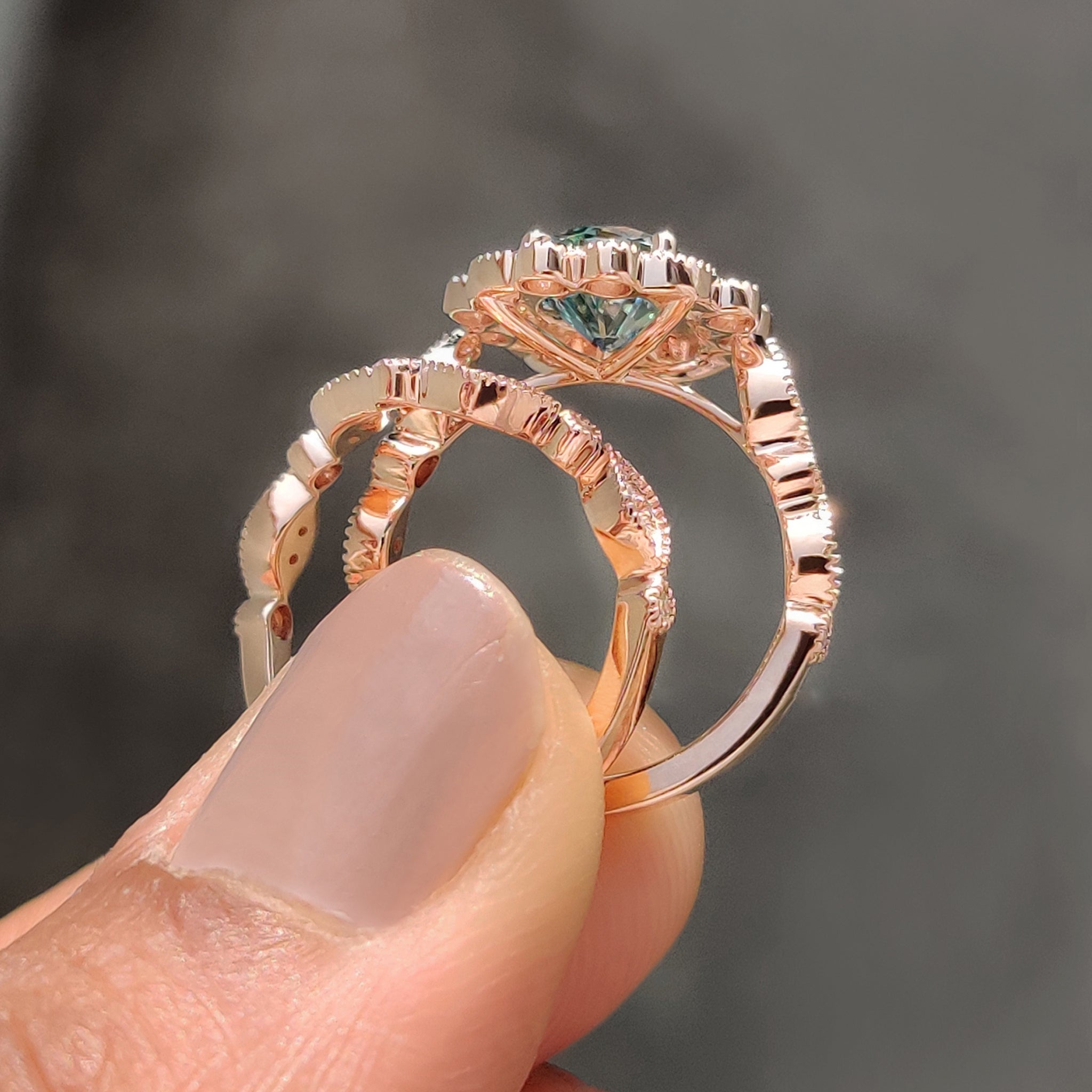 Cyan blue moissanite ring in a rose gold bridal set with a vintage style.
