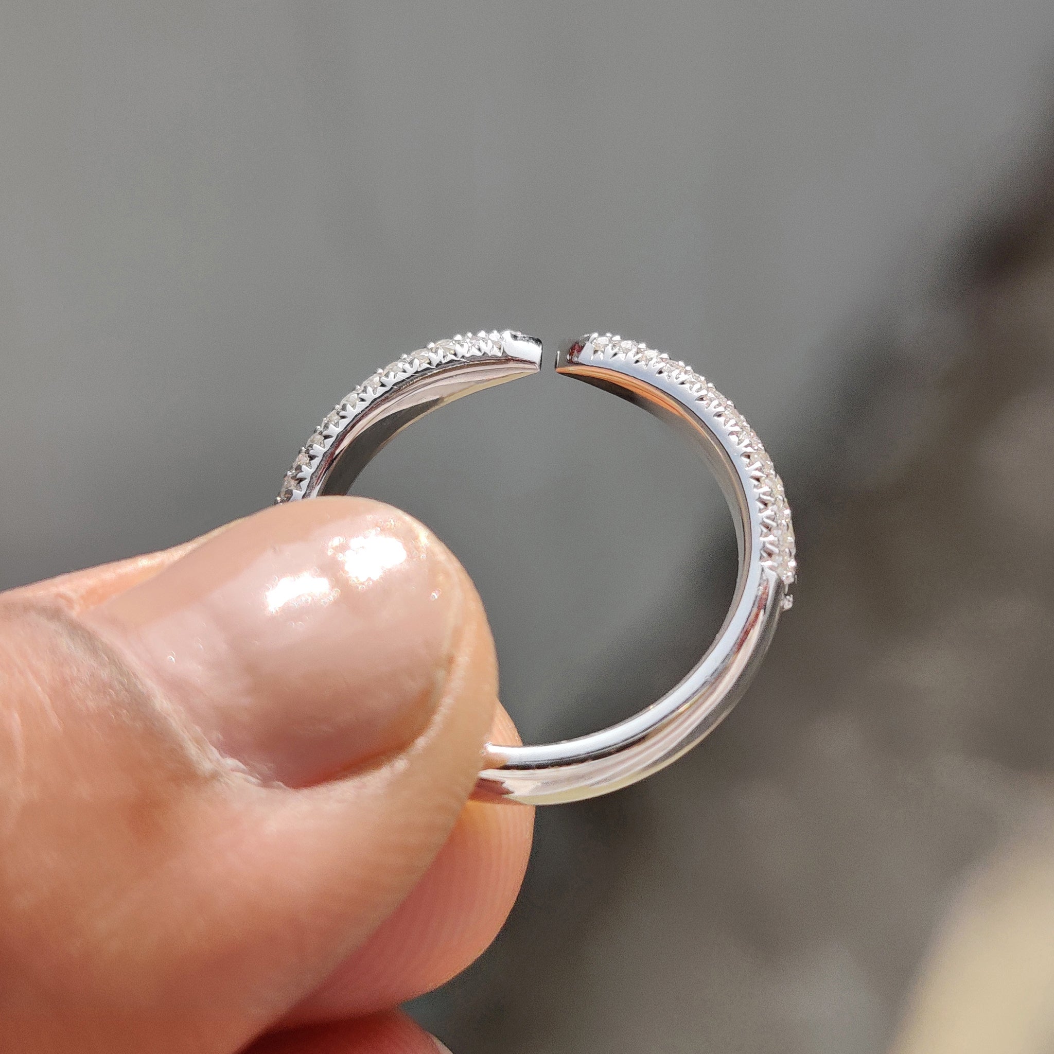 Stackable wedding band featuring round moissanite, ideal for layering with other rings.