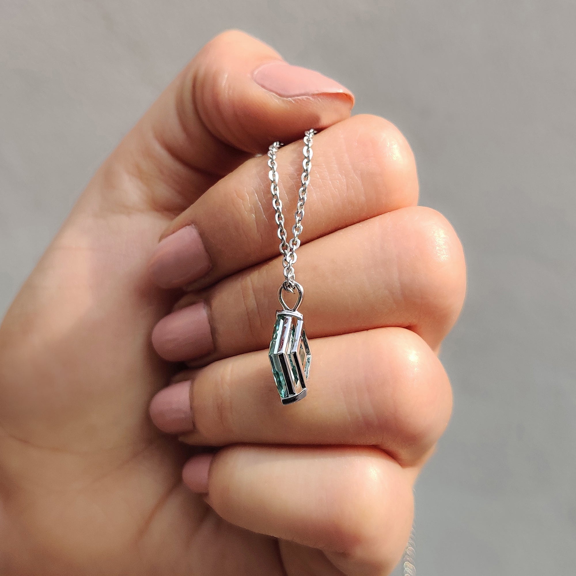 Solitaire pendant created in white gold pendant with bezel set pendant design.
