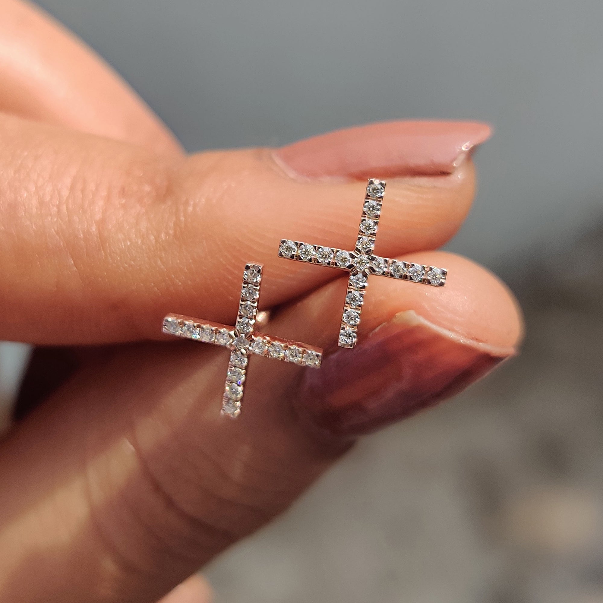 X shaped Moissanite Earrings crafted in rose gold earrings with prong earring settings.
