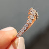 Anniversary gift for her with a custom curvy moissanite band in prong setting.
