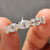 Five stone wedding band featuring oval cut moissanite set in yellow gold.