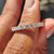 Rose gold wedding band featuring round cut diamonds
