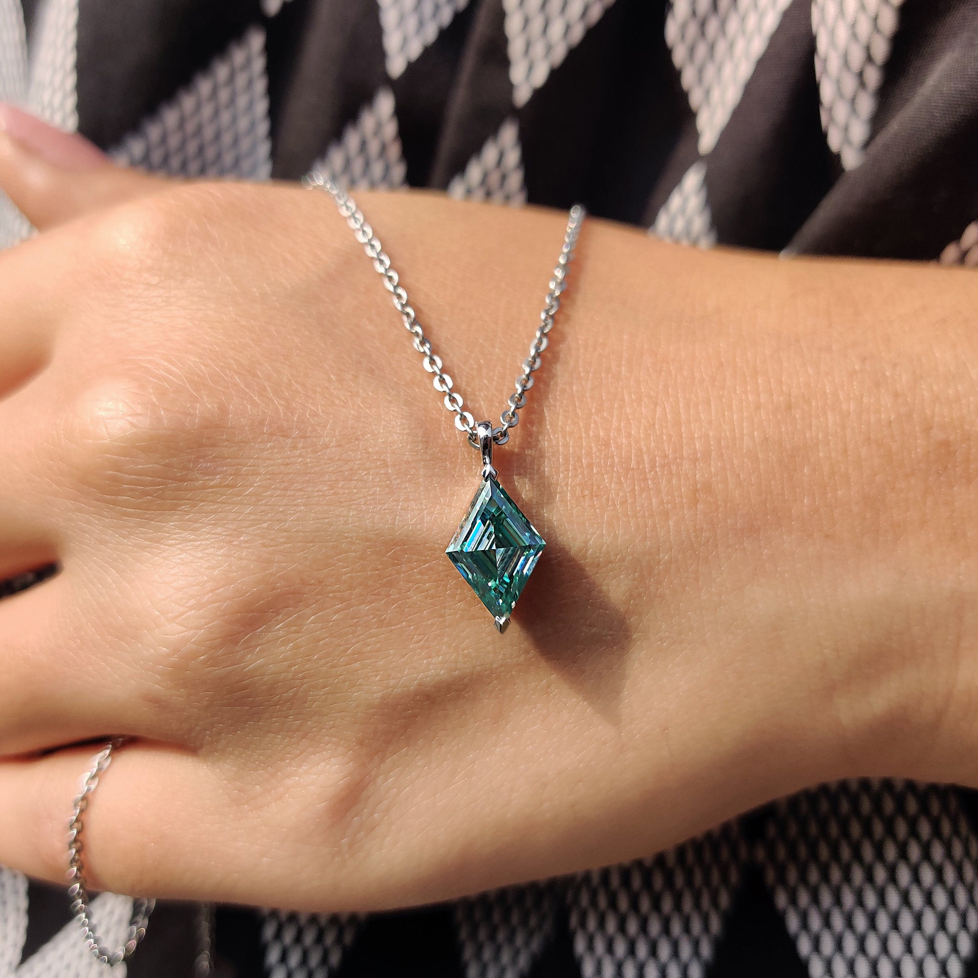 Cayn blue moissanite pendant made as a delicate solitaire pendant with custom pendant option.
