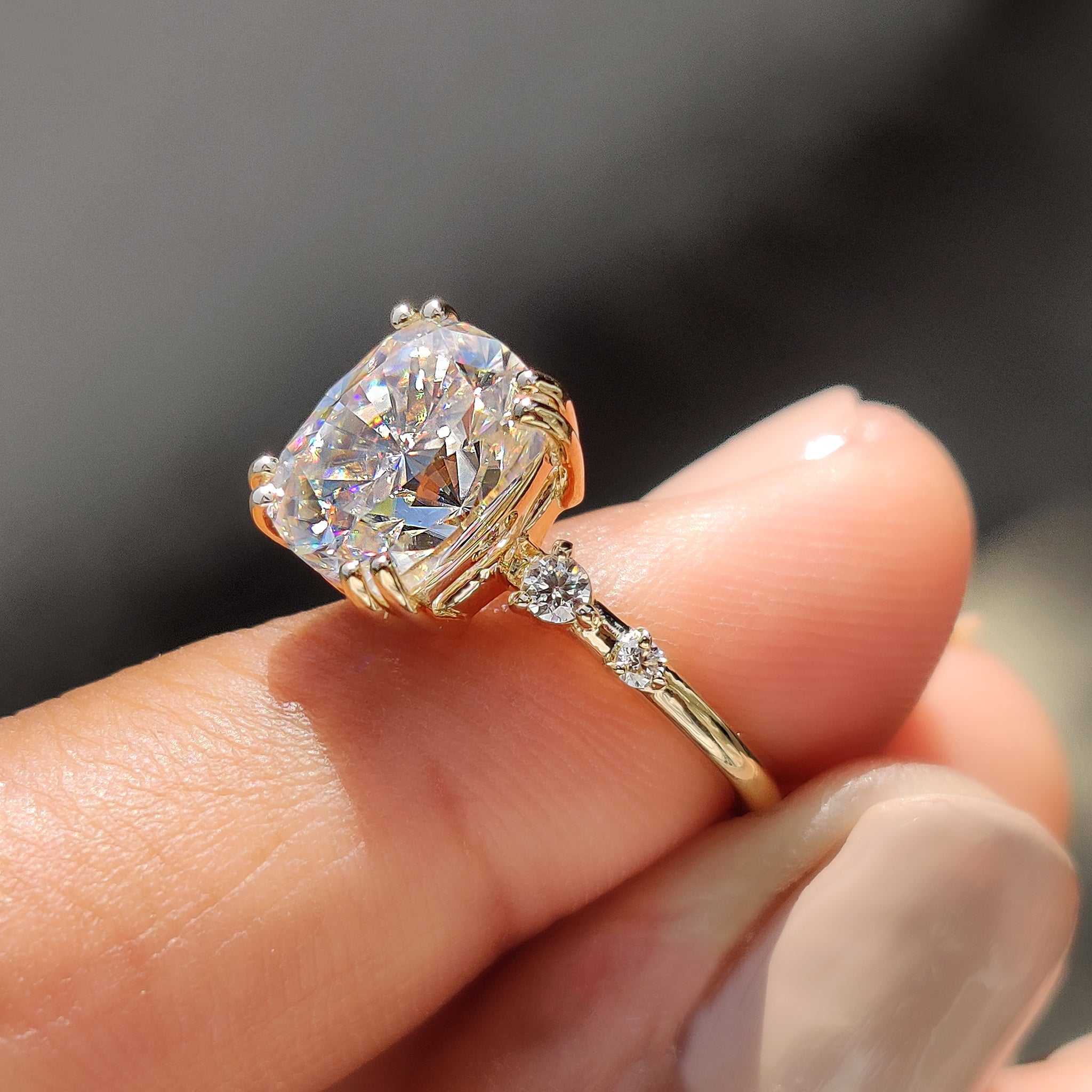 Yellow gold engagement ring featuring round cut stones.
