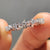 Moissanite eternity band featuring continuous stones around the band, ideal for a classic wedding look.