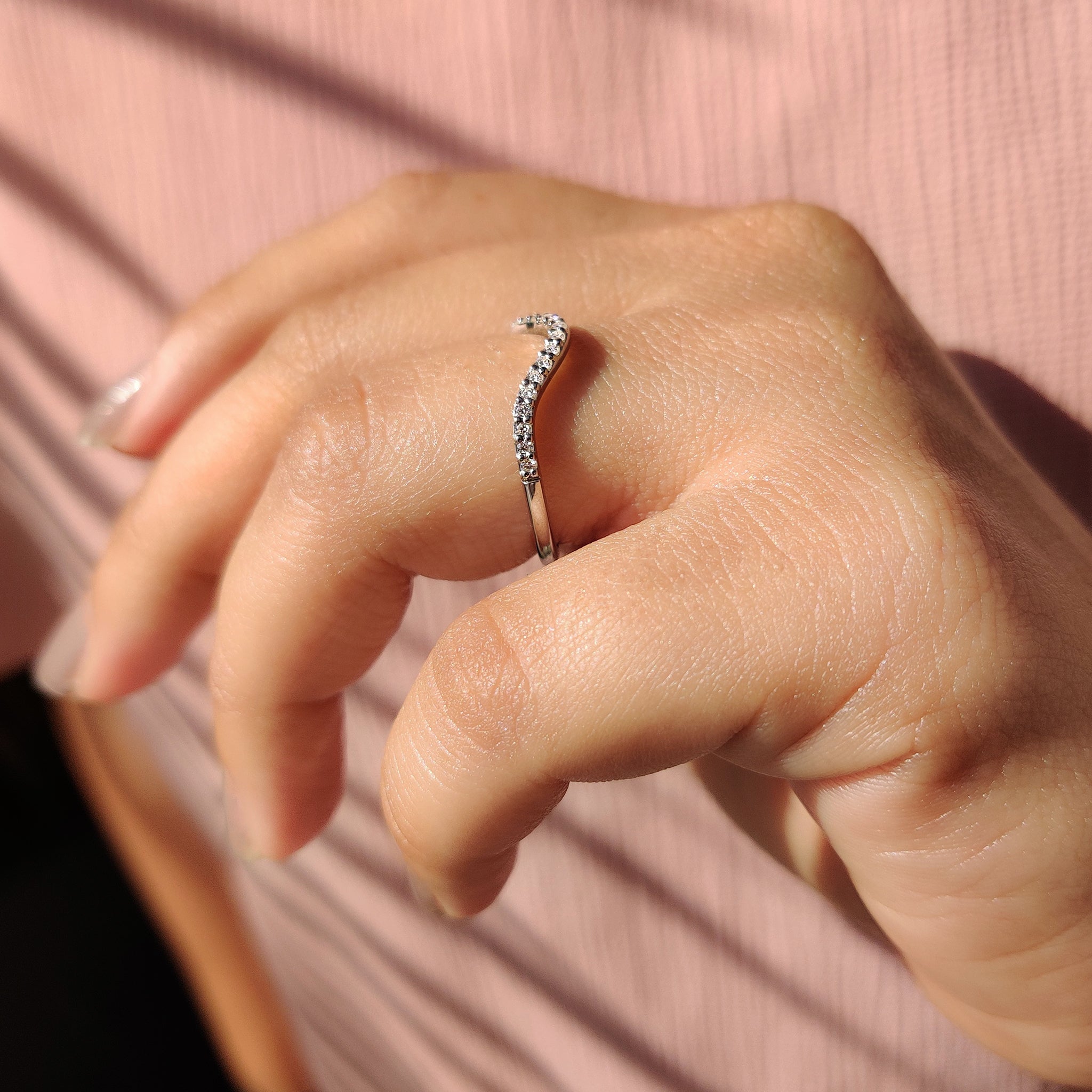 Curvy Wedding Band with prong set diamonds.
