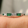 Emerald and diamond wedding band designed for timeless elegance and vibrant beauty.

