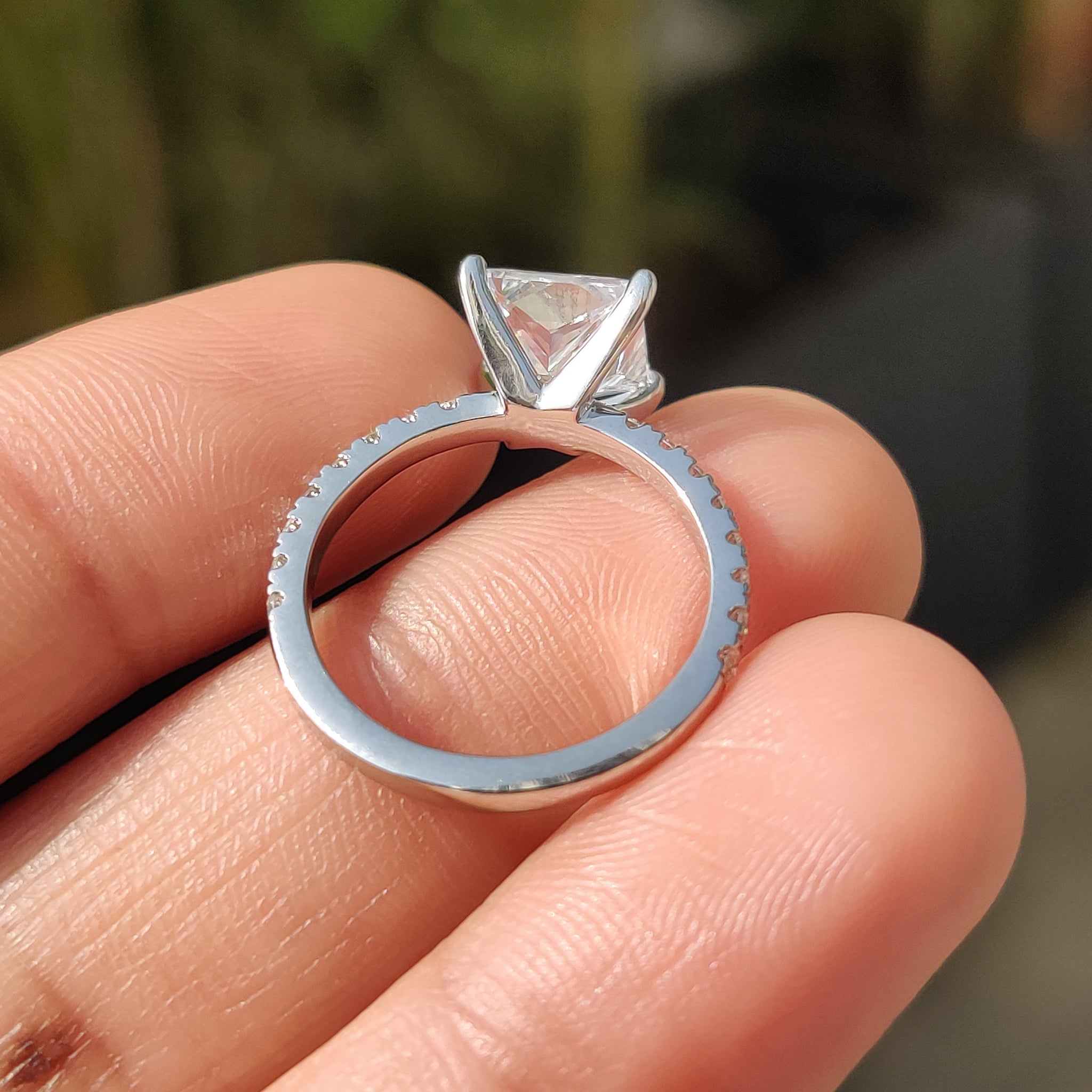 White gold diamond ring featuring intricate pave details.
