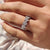 Prong set band featuring moissanite stones in a garland-style eternity layout.

