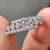 Three row pave wedding band with round moissanite.