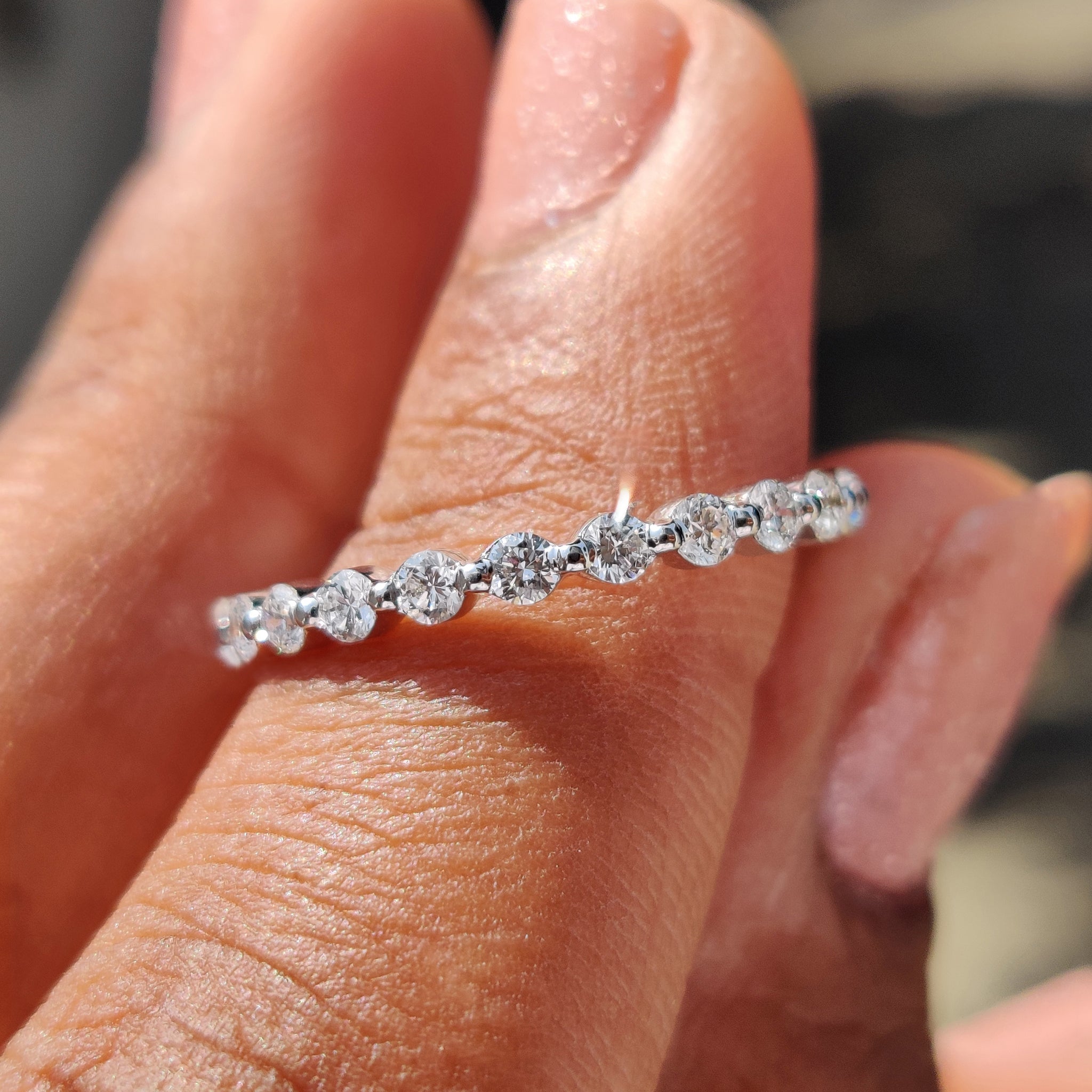 White gold eternity band with sparkling diamonds.
