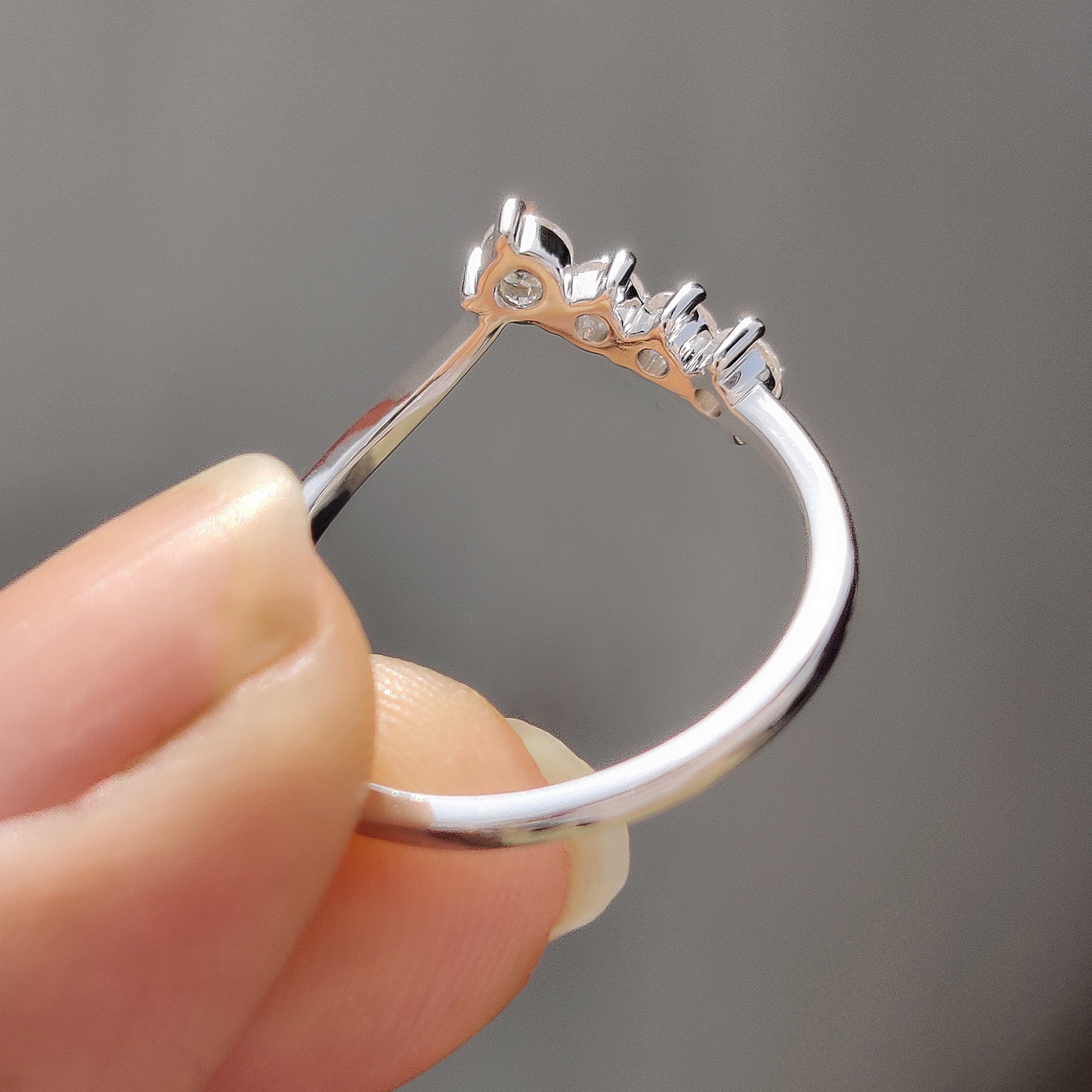 Chevron wedding band with milgrain edges and shared prong setting.